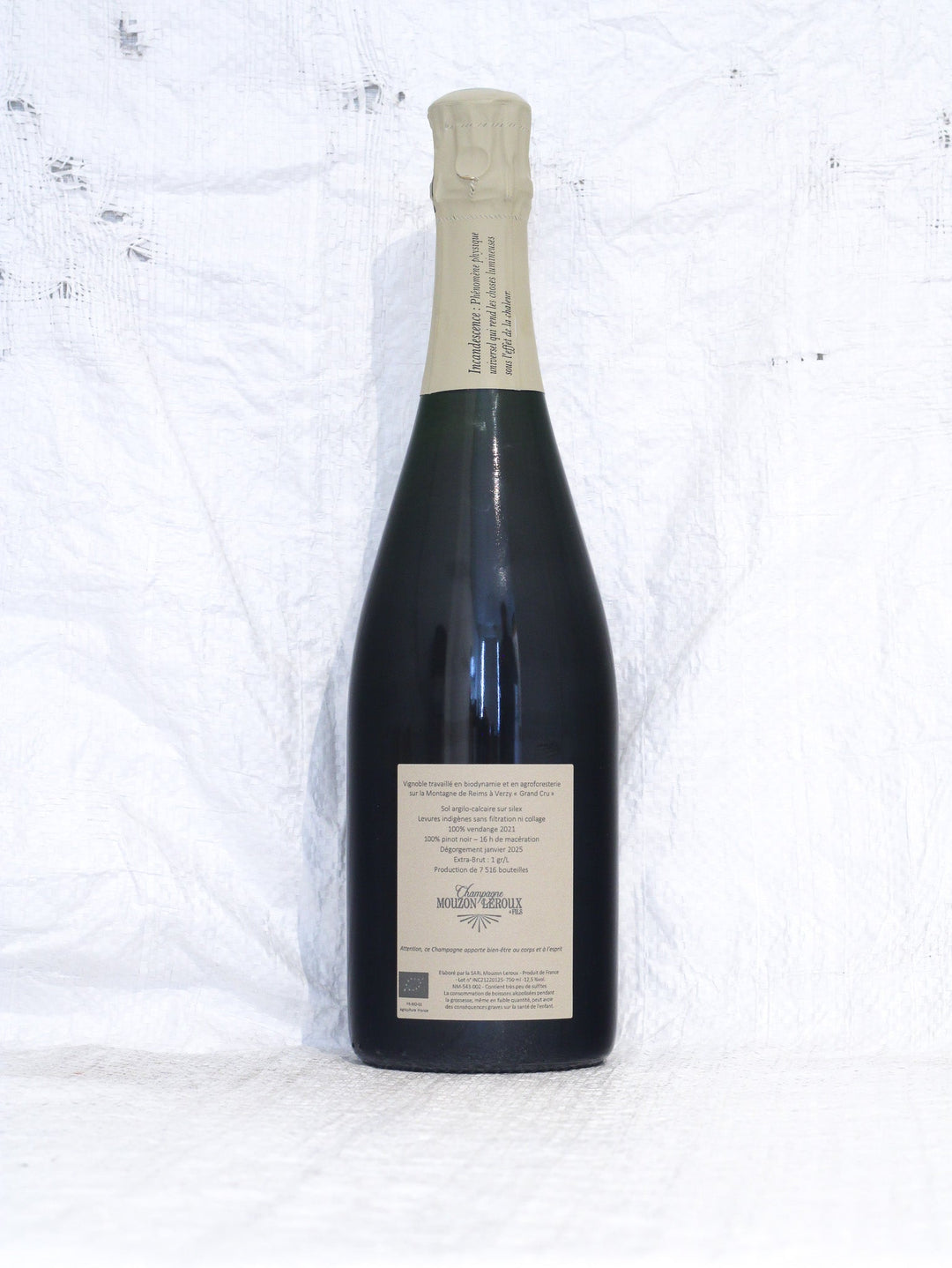Rückansicht der L'Incandescent 2021 Bio Champagnerflasche von Mouzon-Leroux mit Rückenetikett, Angaben zu Grand Cru Verzy und Extra Brut Pinot Noir